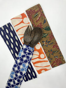 A fork and spoon cutlery set made from coconut timber in batik offcuts pouch